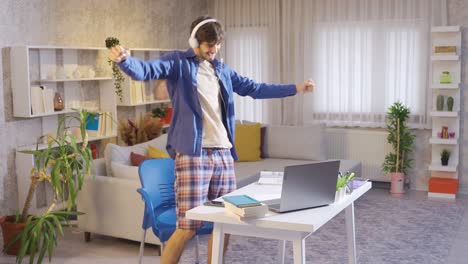 Rejoiced-male-student-dancing-at-home-enjoying-the-good-news.